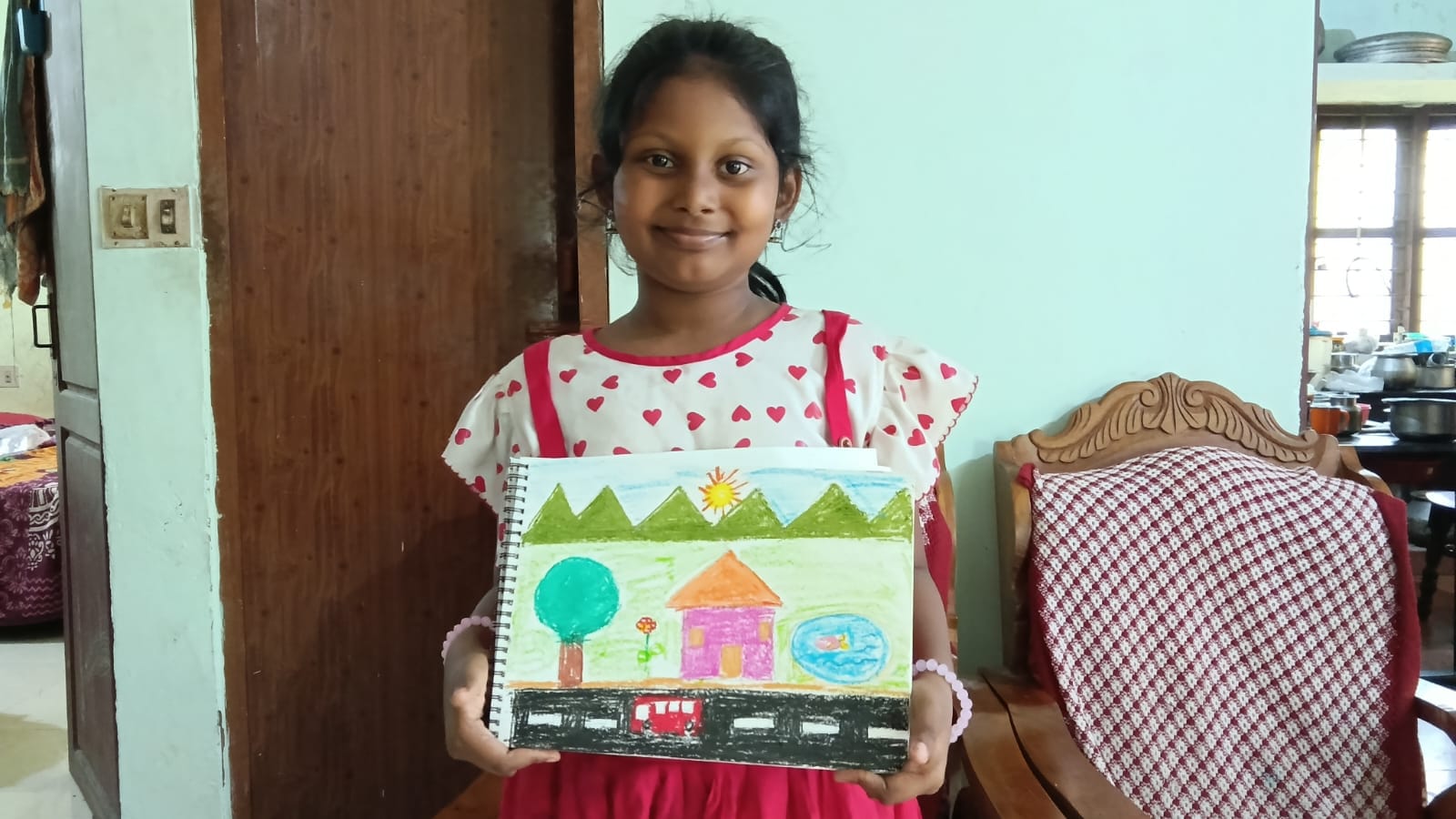 Maram little artist 9 showing their artwork