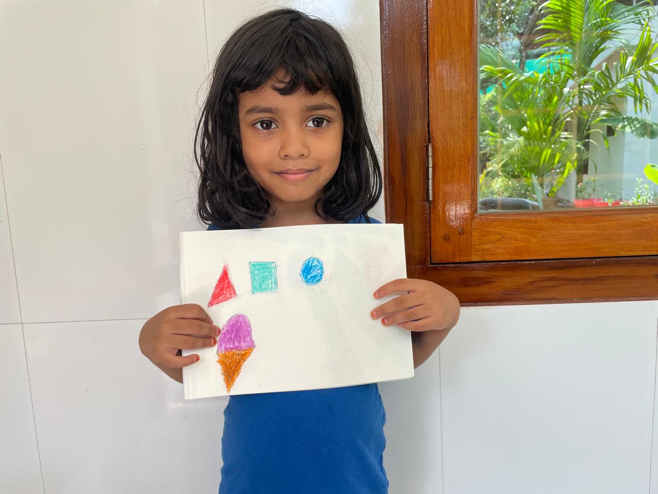 Maram little artist 6 showing their artwork