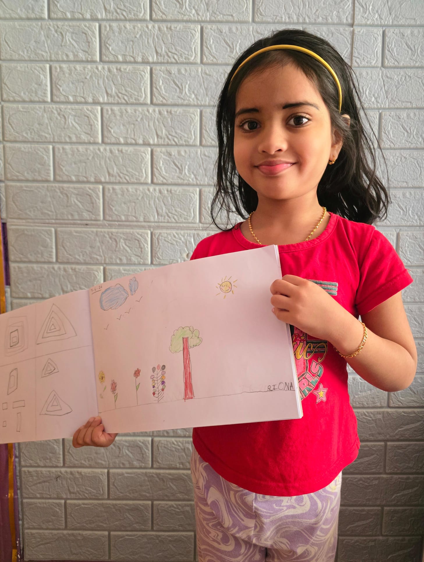 Maram little artist 4 showing their artwork